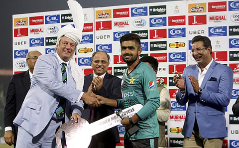 Pakistani cricketer Babar Azam, center, receives man of the match award from Director of the International Cricket Council (ICC) Giles Clarke at the end of the first Twenty20 match against World XI. | AP File Photo
