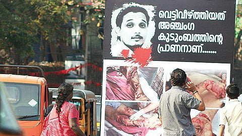 Flex board displaying gory photographs of slain Youth Congress worker Shuhaib in Kannur