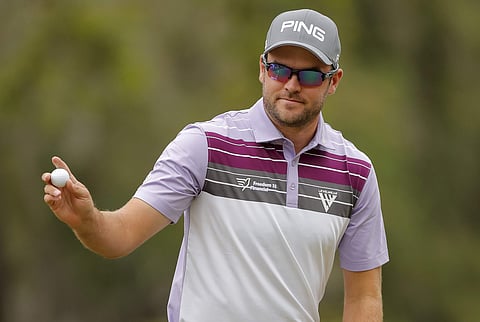 Corey Conners acknowledges the gallery following a putt on the third hole during the third round of the Valspar Championship golf tournament. | AP