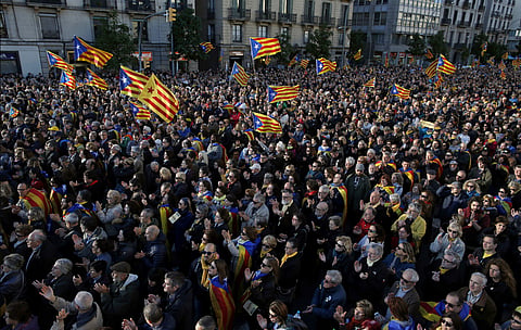 Demonstrators wave Catalan pro-independence 'Estelada' flags during a protest to demand a Catalan republic, called by the pro-independence Catalan National Assembly (ANC) citizens group in Barcelona, Spain, Sunday, March 11, 2018. | AP