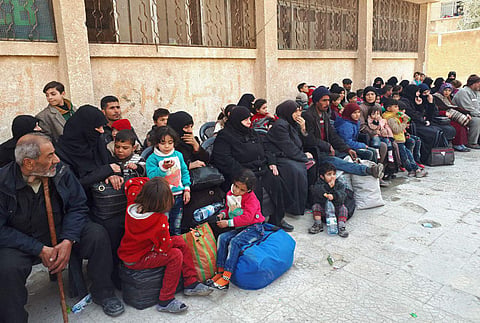 Civilians who fled fighting between the Syrian government forces and rebels, at an army checkpoint, in eastern Ghouta | AP
