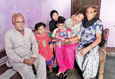 A crestfallen Harvinder Kaur, the wife of Kamaljit Singh, with her parents and two childern in Gazipur village on Tuesday. Kamaljit was among the ill-fated Indians who were killed by ISIS terrorists in Iraq. | Harpreet Bajwa