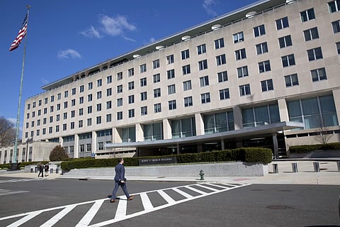 People walk near the U.S. State Department in Washington, Monday, March 26, 2018. | AP