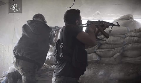 File: Rebel fighters with Failaq al-Rahman, firing their weapons during clashes with government forces in the suburbs of the Syrian capital Damascus. | AP