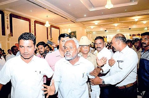 Dalit protesters being led out by police during BJP national chief Amit Shah’s meeting in Mysuru on Friday | Udayshankar S