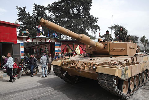 Turkish soldiers atop a tank patrol the northwestern city of Afrin, Syria, during a Turkish government-organised media tour into northern Syria. | AP