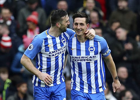 Brighton's Lewis Dunk, right, celebrates scoring his side's first goal of the game. (Photo | AP)