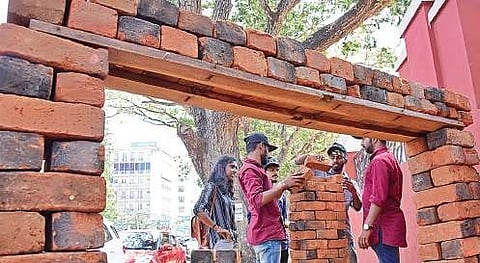 College students use bricks collected from the Attukal Pongala hearths for an installation in T’Puram on Saturday | B P Deepu