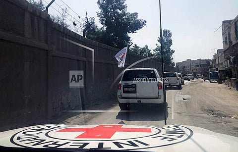 This photo release by the International Committee of The Red Cross, shows a convoy of the Red Cross vehicles headed to eastern Ghouta, a suburb of Damascus, Syria, Monday, March. 5, 2018. Desperate for food and basic medicines, many of the besieged and bo