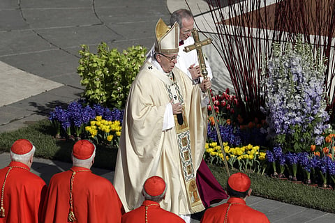 Pope Francis walks with the pastoral staff as he arrives to celebrates the Easter mass in St. Peter's Square at the Vatican. | AP