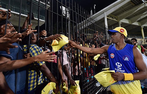 CSK player Bravo distributing T-shirts to fans during a practice session of IPL T20-2018 tournament at the Chepauk (File | PTI)