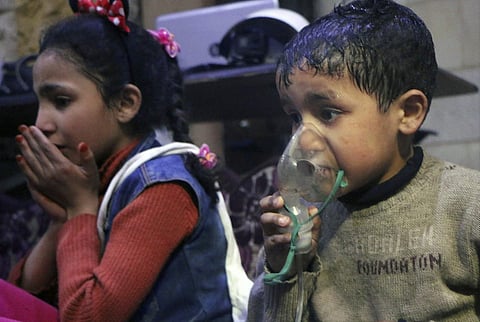 This image released early Sunday, April 8, 2018 by the Syrian Civil Defense White Helmets, shows a child receiving oxygen through respirators following an alleged poison gas attack in the rebel-held town of Douma, near Damascus, Syria. | AP