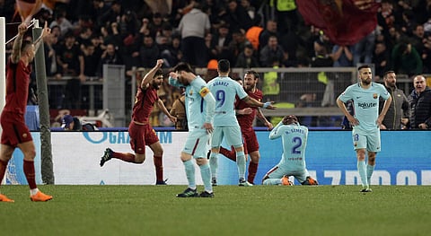 Players react after Roma's Kostas Manolas scored his side's 3rd goal, during the Champions League quarterfinal second leg soccer match between Roma and FC Barcelona at Rome's Olympic Stadium, Tuesday, April 10, 2018. | AP