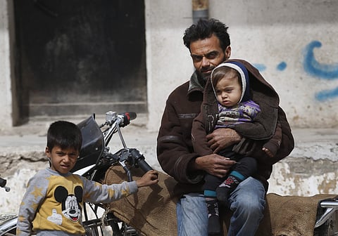 A Syrian man waits outside a food distribution centre in the northwestern city of Afrin. (File | AP)