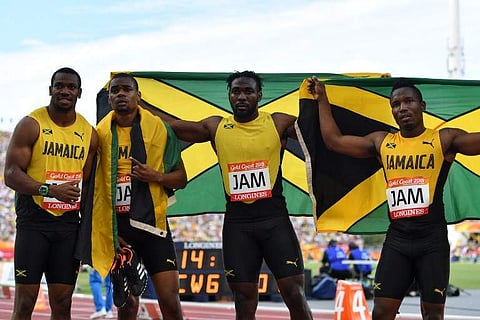 amaica’s Everton Clarke, Oshane Bailey, Warren Weir, Yohan Blake pose with their flag after the athletics men's 4x100m relay final during the 2018 Gold Coast Commonwealth Games at the Carrara Stadium on the Gold Coast on April 14, 2018. (Photo: AFP)