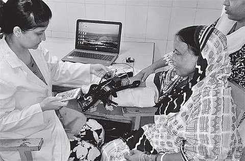 Shifa treating Shakuntala with the help of robotic hand at SVNIRTAR at Olatpur | Express