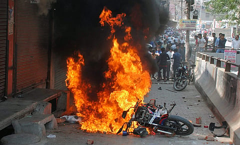 A bike set on fire by a group of protesters during 'Bharat Bandh' call given by Dalit organisations against the alleged dilution of Scheduled Castes / Scheduled Tribes Act in Ghaziabad on Monday. | PTI