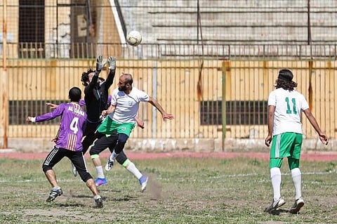 Syrian players fight for the ball during the first football game at Idlib's stadium since three years, in Idlib on April 25, 2018. | AFP