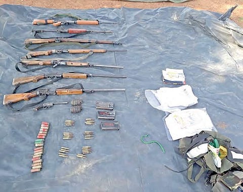 Weapons and a few documents that were recovered from the encounter site that place at Telangana border on Friday | Express