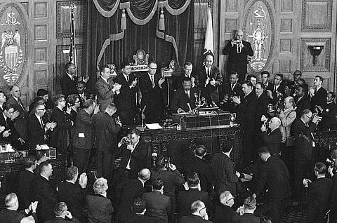In this April 22, 1965 file photo, Dr. Martin Luther King Jr., center, receives applause after finishing a speech to the joint session of the Massachusetts Legislature in Boston, the day before he led a civil rights march to Boston Common. (Associated Pre