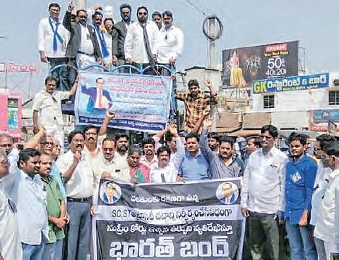 Dalit leaders staging a demonstration in front of Ambedkar statue in Bhimavaram as part of Bharat Bandh on Monday | EXPRESS