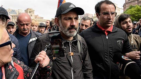 Armenia’s opposition leader Nikol Pashinyan is surrounded by journalists and supporters in Yerevan, April 22, 2018. | AFP