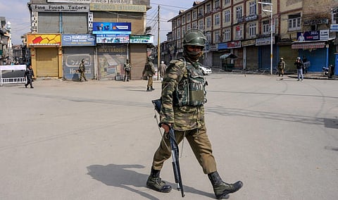 Security personnel guard in a street during curfew-like restrictions imposed by the authorities to maintain law and order in Srinagar. (File photo | PTI)