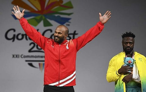 Sathish Kumar Sivalingam (L) celebrates after winning the gold medal in the men's 77kg weightlifting event as Australia's bronze medallist Francois Etoundi (R) looks on. (Photo | AFP)