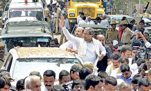 Siddaramaiah at a roadshow in Chamundeshwari recently. The Chief Minister has decided to shift to this constituency vacating the neighbouring Varuna constituency for his son Yathindra (in the background)
