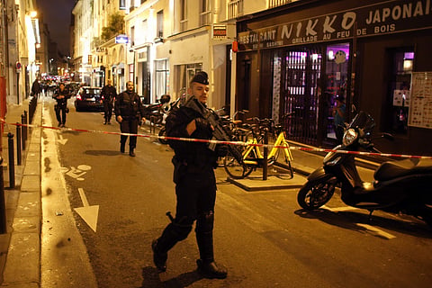 A police officer cordons off the area after a knife attack in central Paris. | AP