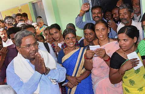 Karnataka Chief Minister Siddaramaiah greets his supporters after voting in the Karnataka Assembly elections 2018 at Hundi village in Mysore on Saturday. | PTI