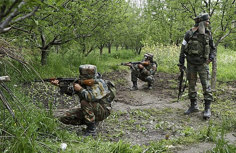 In this file photo, army personnel taking positions in an orchard field during a crackdown at a village in Shopian district in South Kashmir. (Photo | PTI)