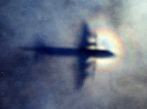 FILE - In this March 31, 2014 file photo, the shadow of a Royal New Zealand Air Force P3 Orion is seen on low level cloud while the aircraft searches for missing Malaysia Airlines Flight MH370 in the southern Indian Ocean, near the coast of Western Austra