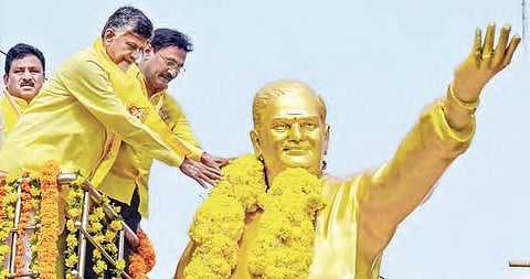 Chief Minister N Chandrababu Naidu garlanding the statue of NTR on his birth anniversary at NTR circle in Vijayawada on Monday | P Ravindra Babu