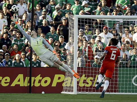 Wales goalkeeper Wayne Hennessy makes a save as Mexico's Jonathan Dos Santos looks on | AP