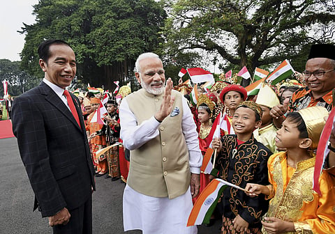 Prime Minister Narendra Modi interacts with children who greeted him during his ceremonial welcome at Istana Merdeka. | PTI