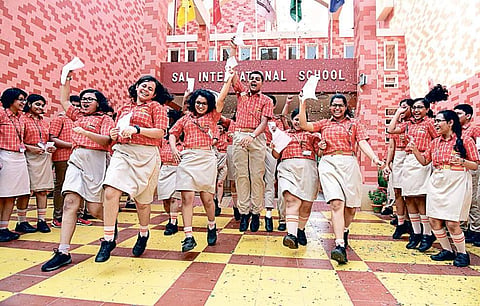(Left) Students of Sai International School rejoice and those of BJEM take selfie after the CBSE results were declared on Tuesday | Express