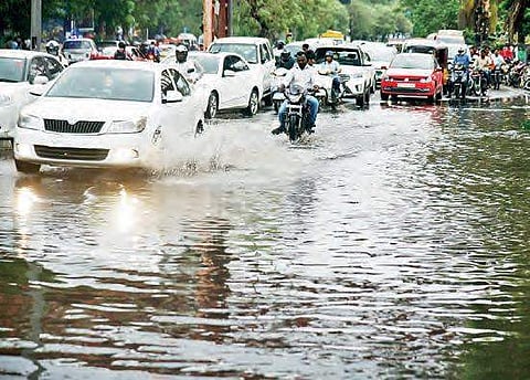 Motorists have a tough time commuting on a water logged road, in Hyderabad on Thursday. Most parts of the city received 10-20 mm rainfall in a matter of hours | R Satish Babu