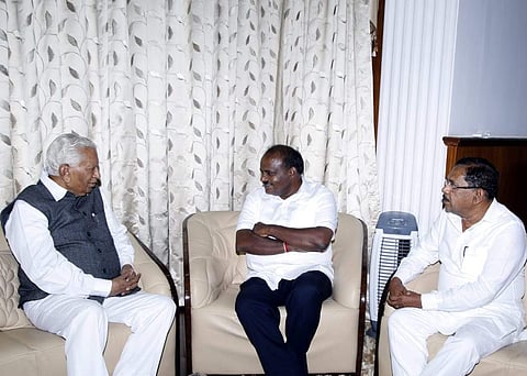 Chief Minister H D Kumaraswamy and Deputy Chief Minister Parameshwara met Governor Vajubhai Vala at Rajbhavan in Bengaluru on Friday. (EPS)