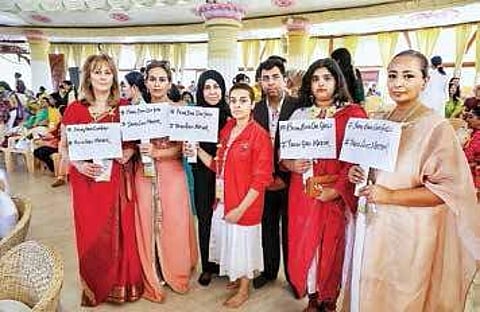 women holding Twitter hashtag placards in favour of Yazidi women at the International Women’s Conference at The Art of Living headquarters in Bengaluru | Pushkar V