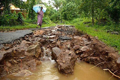 Roads connecting Karimbu and Anakkampoyil in Kozhikode seen eroded away due to gushing water during the heavy monsoon rain . (EPS | Manu R Mavelil)