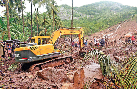 Rescue workers trying to recover bodies trapped underneath the mud at Karinchola in Kozhikode after a landslide | Manu R Mavelil