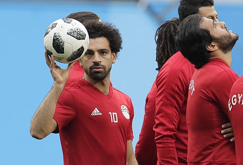 Egypt's Mohamed Salah, left, plays with the ball during Egypt's official training on the eve of the group A match between Russia and Egypt at the 2018 soccer World Cup in the St. Petersburg stadium. | AP