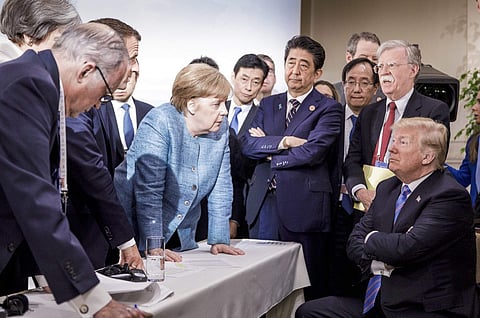 In this photo made available by the German Federal Government, German Chancellor Angela Merkel, center, speaks with U.S. President Donald Trump, seated at right, during the G7 Leaders Summit. | AP