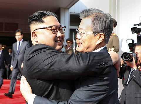 North Korean leader Kim Jong Un, and South Korean President Moon Jae-in embrace each other after their meeting at the northern side of the Panmunjom in North Korea, Saturday, May 26, 2018. | AP
