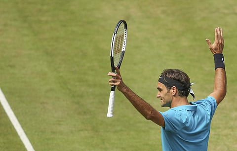 Roger Federer celebrates after he beats Matthew Ebden during their match at the Gerry Weber Open tennis tournament in Halle. (AP)
