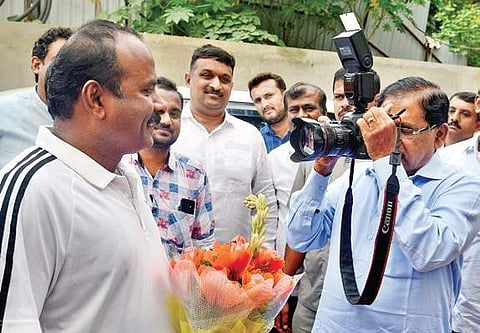 Deputy Chief Minister G Parameshwara clicks a picture of Bengaluru Mayor Sampath Raj before inspecting the multi-level car parking facility near Freedom Park on Thursday | Pushkar V