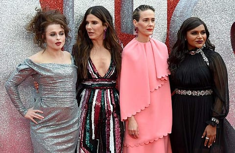 English actress Helena Bonham Carter (L), US actor Sandra Bullock (2L), US actor Sarah Paulson (2R) and US actor Mindy Kaling pose on the carpet upon arrival to attend he European premiere of the film ' Ocean's 8' in London on June 13, 2018. | AFP