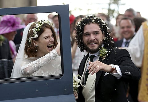 Actors Kit Harington and Rose Leslie react as they leave after their wedding ceremony, at Rayne Church, Kirkton of Rayne in Aberdeenshire, Scotland, Saturday June 23, 2018. | AP