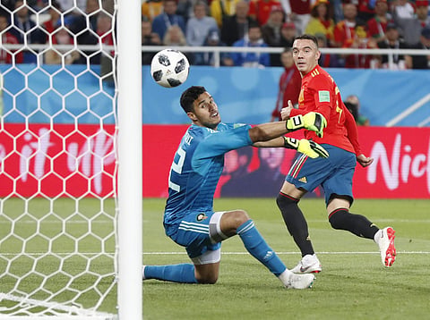 Spain's Iago Aspas, right, scores his side's second goal past Morocco goalkeeper Monir El Kajoui, during the group B match between Spain and Morocco at the 2018 soccer World Cup at the Kaliningrad Stadium in Kaliningrad. | AP